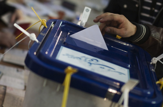 A man casts his vote during the parliamentary election in central Tehran