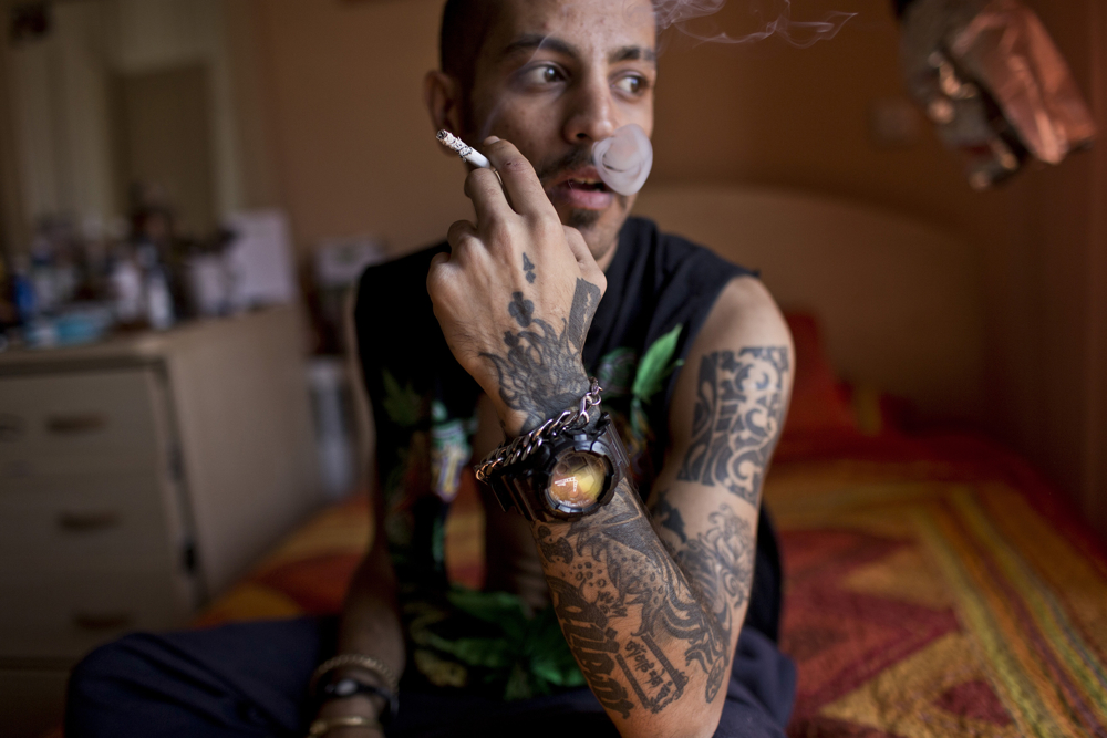 Siavash, a tattooist, smokes a cigarette. While not illegal, Islamic law is often used to denouce those sporting them.